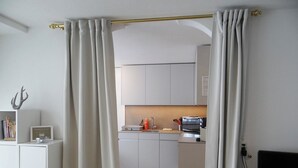 A modern kitchen with white cabinets, a microwave, and a sink. - Sunnmatt 752 Appartement/Fewo 3-Bettwohnung by Interhome (Engelberg)