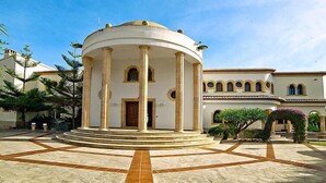 A circular building with columns, a central door, and a tiled courtyard. - St Anthony by Interhome (Jávea)