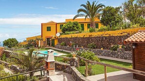 A resort with a swimming pool, stone walls, and tropical plants. - Camino La Candelaria by Interhome (La Orotava)