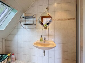 A bathroom with a sink, mirror, towel rack, and a window. - Eifelhome Two nahe Nürburgring by Interhome (Antweiler)