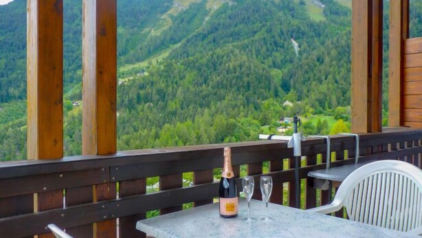 A terrace with a table and chairs, overlooking a mountainous landscape. - Hauts de Morthey No 33 by Interhome (Ovronnaz)