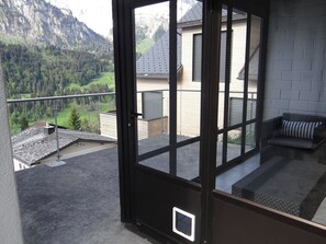 A balcony with a view of a mountainous landscape.