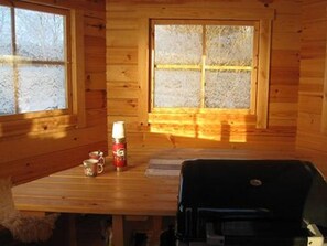 Cozy cabin-style room with a table for casual dining and cooking.