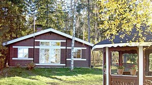 A wooden cabin with a small porch and a window with shutters. - Alahuone by Interhome (Asikkala)