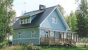 A two-story house with a porch, a chimney, and a grassy yard. - Eteläranta by Interhome (Hankasalmi)