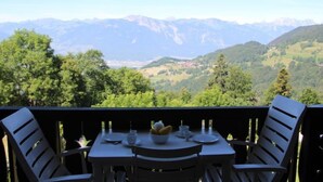 A table set outdoors with a mountain view. - Ambassadeur 15 by Interhome (Villars)