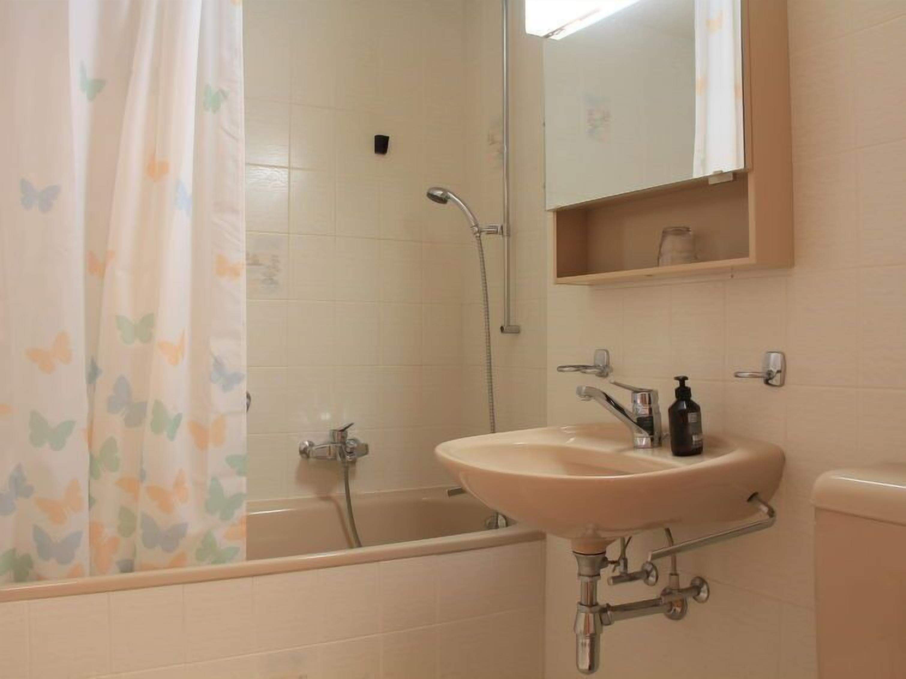 A bathroom with a bathtub, a sink, and a toilet.