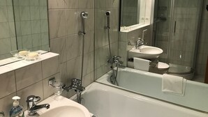 A modern bathroom with a bathtub, a shower, and a sink. - Disentiserhof Hönig by Interhome (Disentis)
