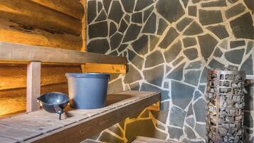A wooden bench with a metal bucket and a metal bowl on a wooden ledge.