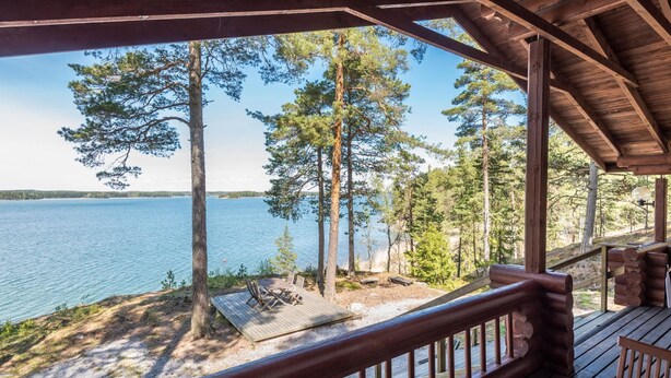 A wooden deck with a view of a lake and trees. - Merimetso by Interhome (Sauvo)