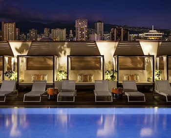 Outdoor pool, cabanas (surcharge), pool umbrellas at Halepuna Waikiki by Halekulani