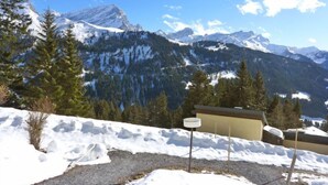 A snowy mountain landscape with a building in the foreground. - La Vire D'Aufalle 14 Inférieur by Interhome (Alpe des Chaux)