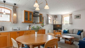 A compact living space with a kitchen, dining area, and seating area.