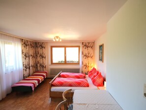 A room with two single beds, a chair, a radiator, a window, and a picture on the wall. - Jägerhof by Interhome (Schwaz)