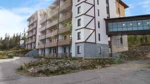 A multi-story building with balconies and a modern architectural design.