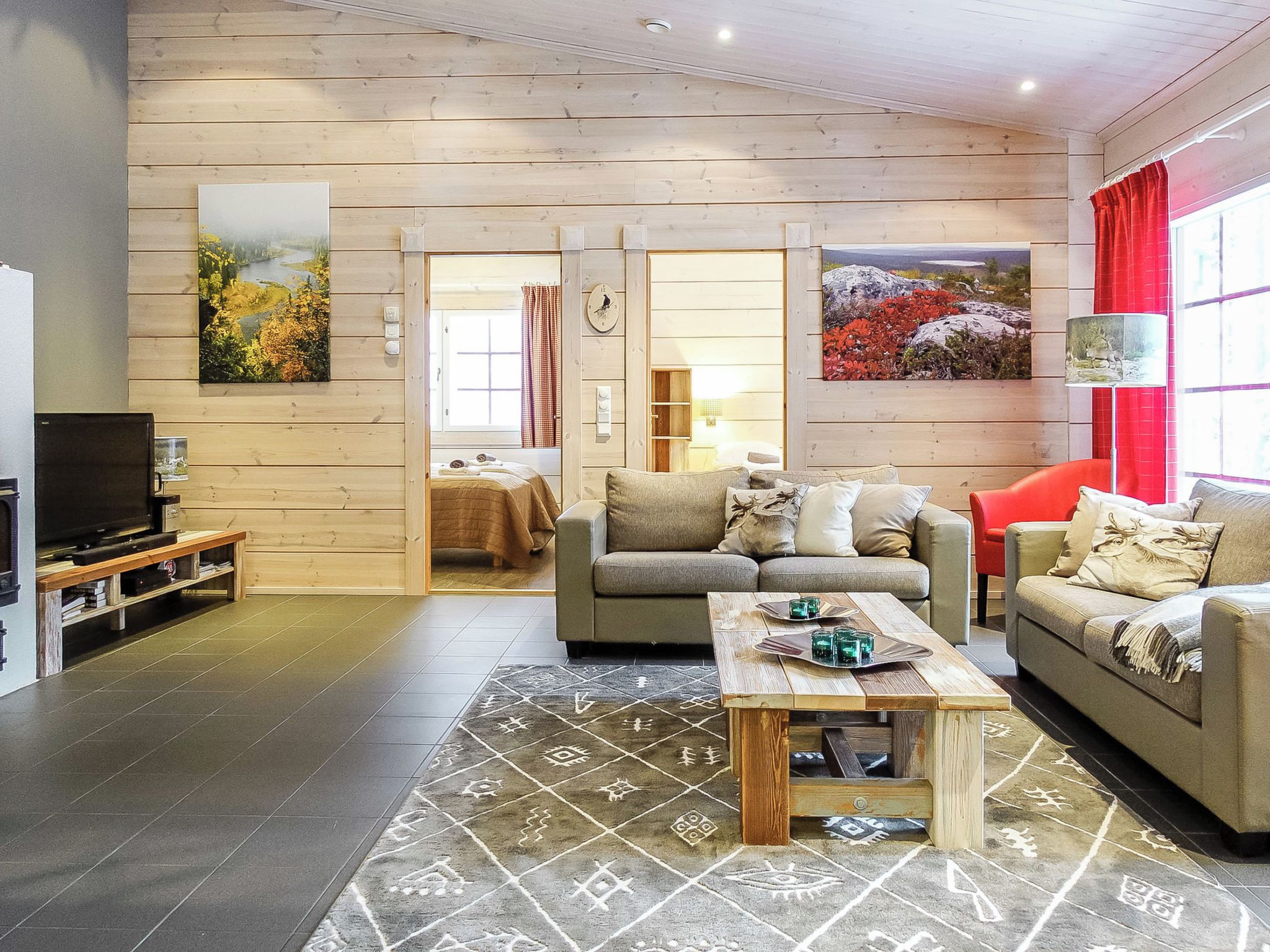 A cozy living room with a sofa, a coffee table, and a television.