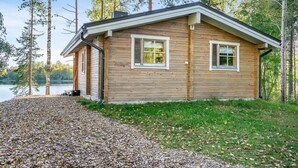 A wooden cabin with two windows, a porch, and a gravel path leading to it. - Lahdenpohja, vaikon loma 7 by Interhome (Kaavi)