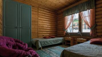 A cabin with two beds, a desk, and a chair.