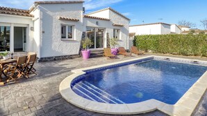 A residential property with a swimming pool, patio furniture, and a white exterior. - Montgri by Interhome (Empuriabrava)