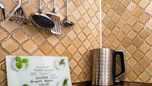 A kitchen with a stainless steel mug, a menu board with various herbs, and kitchen utensils hanging on the wall. - Kiefer (A907) by Interhome (Lahnstein (Koblenz))