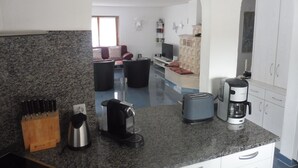 A kitchen with granite countertops, a coffee maker, a toaster, and a knife block. - Theresli by Interhome (Saas-Almagell)