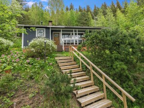 A wooden staircase leading to a cabin with a porch, surrounded by dense forest. - Rantapelto by Interhome (Mikkeli)