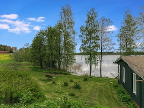 A lakeside property with a wooden cabin, a swing, and a boat dock. - Rantapelto by Interhome (Mikkeli)