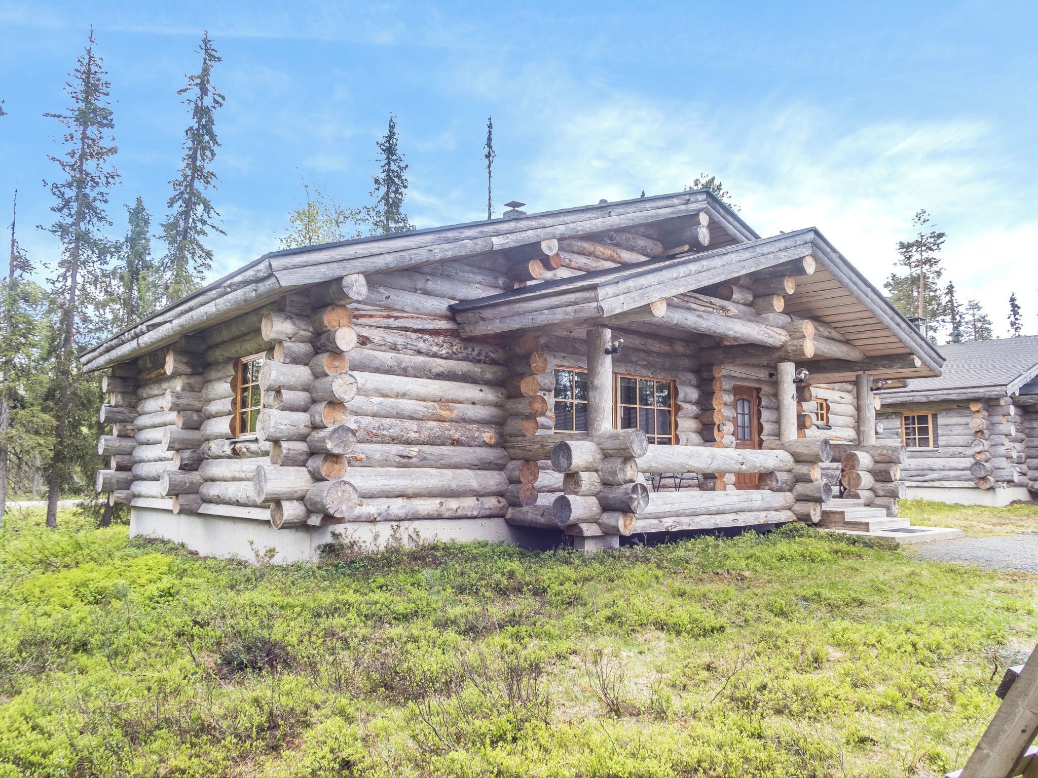 A log cabin with a porch and a chimney.