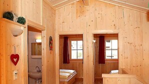 A wooden cabin with a bathroom, a bed, and a window. - Schwendau by Interhome (Mayrhofen)
