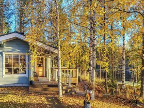 A cabin with a porch, surrounded by trees with yellow leaves. - Sointukallio by Interhome (Savonlinna)