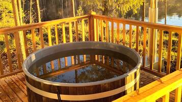 A wooden deck with a hot tub.