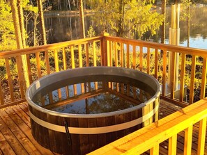 A wooden deck with a hot tub. - Sointukallio by Interhome (Savonlinna)