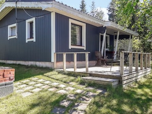 A residential building with a porch, a brick fireplace, and a small deck area. - Rantala by Interhome (Kaavi)