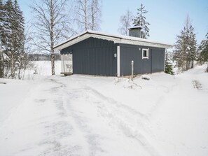 A single-story building with a dark exterior, a small window, and a chimney. - Rantala by Interhome (Kaavi)