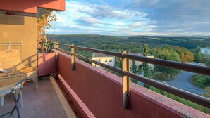 A balcony with a view of a forested valley and a road. - Amsel (A410) by Interhome (Lahnstein (Koblenz))