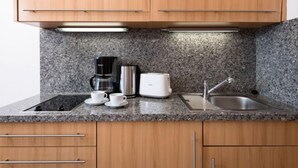 A kitchen with granite countertops, a coffee maker, a toaster, and a sink. - Amsel (A410) by Interhome (Lahnstein (Koblenz))