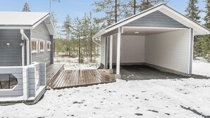 A cabin with a covered porch and a small deck area.
