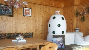 A cozy wooden cabin interior with a wooden dining table, chairs, a bench, and a sofa. - Berghof Reich by Interhome (Längenfeld)