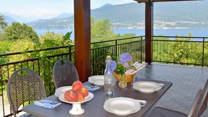 A table set for two with a view of a lake and mountains. - Rossella by Interhome (Castelveccana)