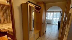 A hallway with a bed, a wardrobe, and a door leading to another room. - Am Gilsbach 2 by Interhome (Adelboden)