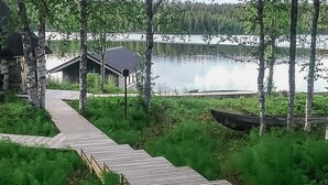 Un muelle de madera que conduce a una cabaña junto a un lago.