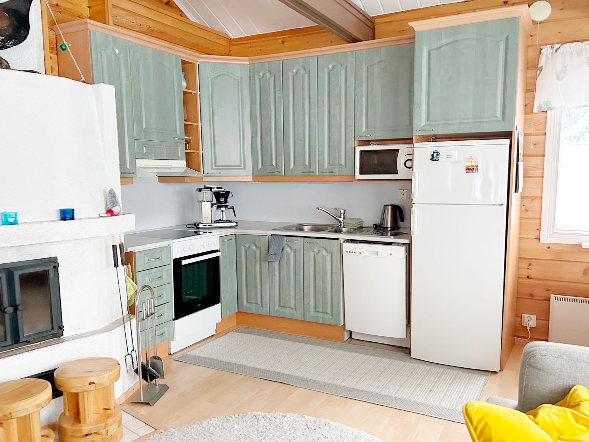 A compact kitchen with a microwave, refrigerator, oven, and dishwasher.