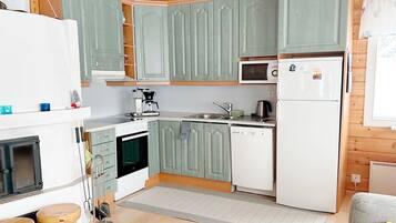 A compact kitchen with a microwave, refrigerator, oven, and dishwasher.