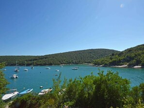 Enjoy a tranquil marina setting with breathtaking views of the calm waters and lush green hills.