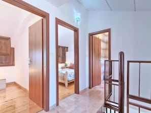 Cozy retreat with a bed, bedside table, and wardrobe.