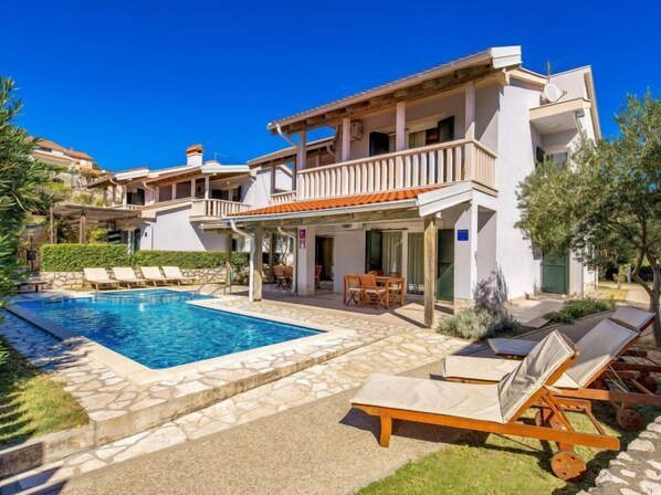 A two-story villa with a swimming pool, outdoor seating, and a covered patio area. - Mihaela 1 by Interhome (Rab/Rab)