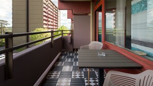 A balcony with a tiled floor, a table, and two chairs. - Auszeit (B403) by Interhome (Lahnstein (Koblenz))