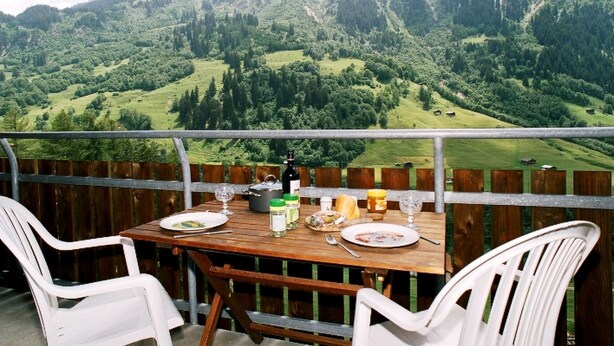 A table set for two with a mountain view. - Disentiserhof Aua Cotschna Avvanzino by Interhome (Disentis)