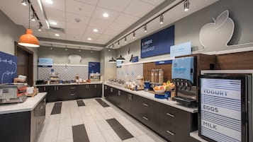 A modern breakfast area with a self-serve station, a yogurt dispenser, and a digital menu board.