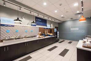 A modern breakfast area with a counter, food display, and a wall sign reading 'GOOD MORNING'. - Holiday Inn Express & Suites Phoenix North - Happy Valley by IHG (Phoenix)